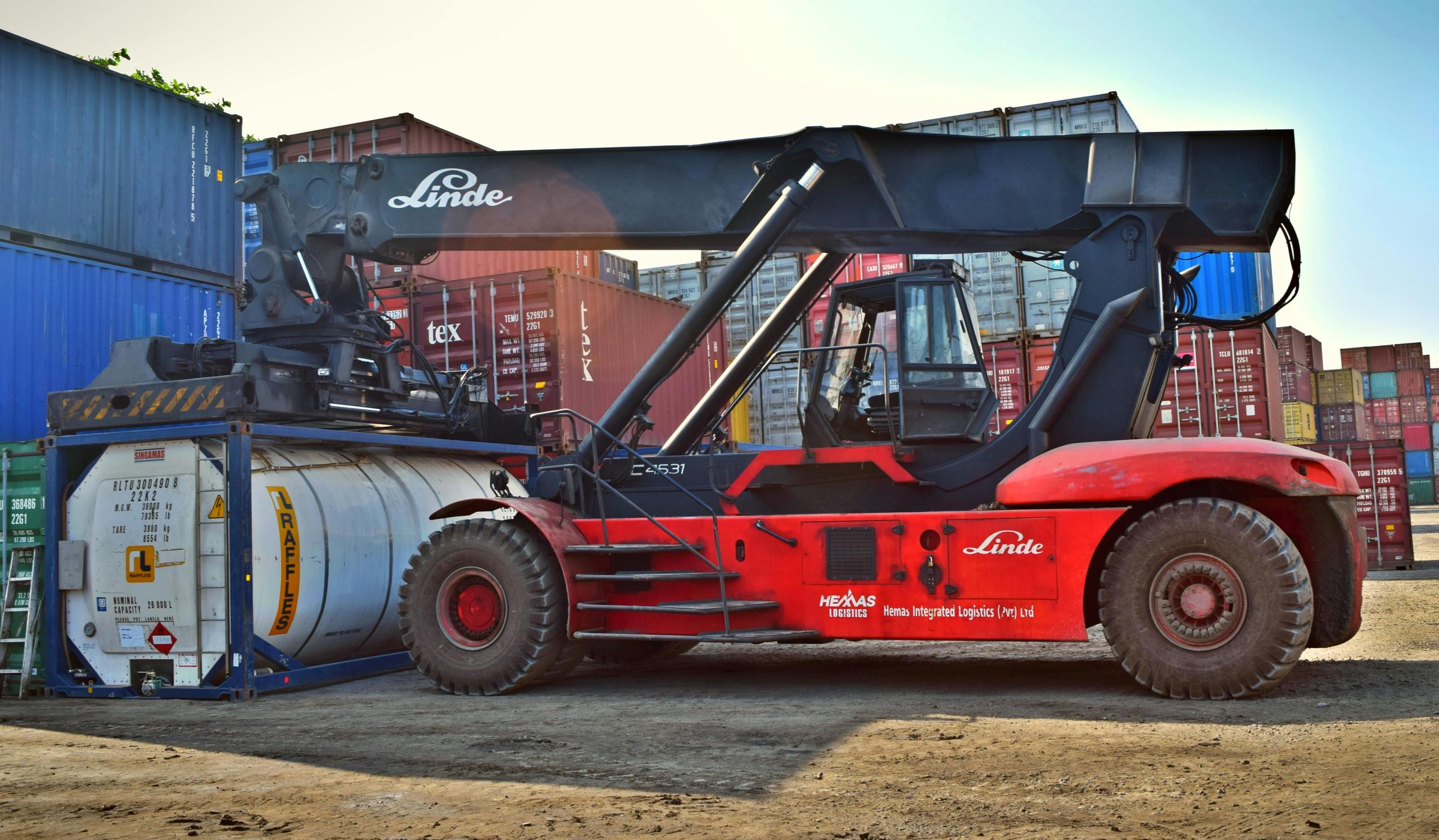 Reach stacker handling a tank container in the depot